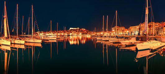 Illuminated spring seascape on Aegean Sea. Calm night view of Kavala city, the principal seaport of...