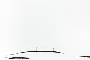 snowy hill with pylons