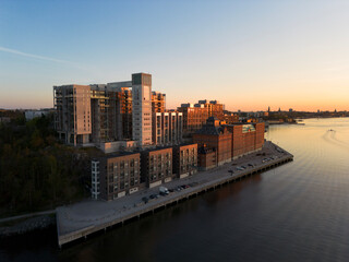Aerial view of Kvarnholmen, residential district in Nacka, Sweden, a suburb of Stockholm, in sunset evening light with industrial style brick buildings by the sea