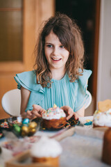 A girl decorates traditional Ukrainian pastries for Easter.