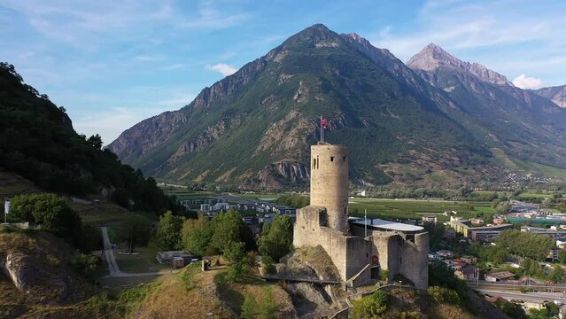 Martigny, Switzerland: Aerial drone footage of the B&acirc;tiaz medieval fort overlooking Martigny city in Canton Valais in the Swiss alps.