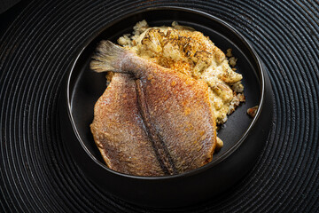 fried flounder with sauce and vegetables