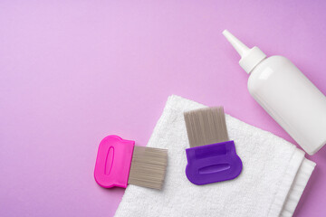 Anti lice combs and towel on pink background