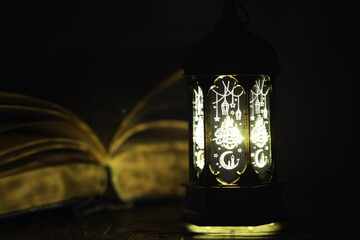 Ornamental Arabic lantern with burning candle glowing at night. Festive greeting card, invitation for Muslim holy month Ramadan Kareem.