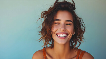 A woman smiling with her eyes closed.