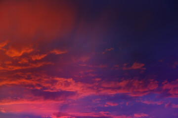 Beautiful sunset sky above clouds with dramatic light. Cabin view from airplane