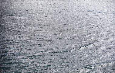 Water surface. The texture of the water. Waves on the lake in windy weather.