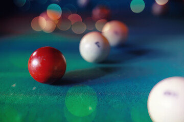 Billiard balls and cue on pool table. Russian billiards. Close-up of items for the game. Background space. Concept of sports games. Place for an inscription or logo. Copy space for site or banner