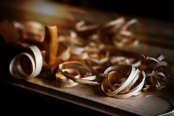 Hand planer with wooden sawdust. On a wooden background. High quality photo