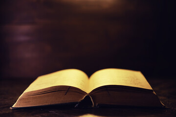 Book on a wooden table background with copy space. Historical atmosphere. Vintage english style. Evidence searching concept. Empty place for text.