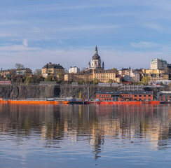 Fototapeta premium View at the bay Strömmen, the blocks at the church Katarina Kyrka, the pier Stadsgården, a sunny summer morning in Stockholm