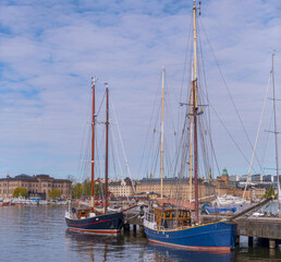 Two old sail pram ships at a pier in the bay Ladug&aring;rdslandsviken, a sunny summer morning in Stockholm