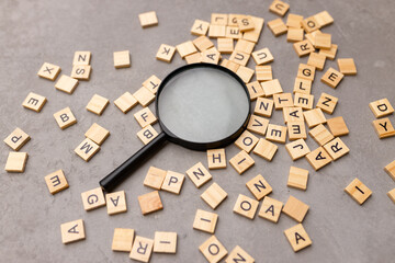 Magnifying glass with many wood letters of English alphabets, learning English concept