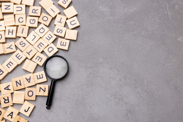 Magnifying glass with many wood letters of English alphabets, learning English concept