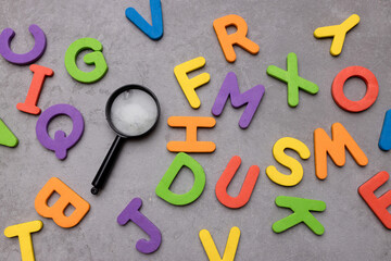 Magnifying glass with many wood letters of English alphabets, learning English concept