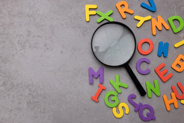 Magnifying glass with many wood letters of English alphabets, learning English concept