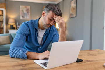 Businessman office working holding sore head pain from desk working and sitting all day using...