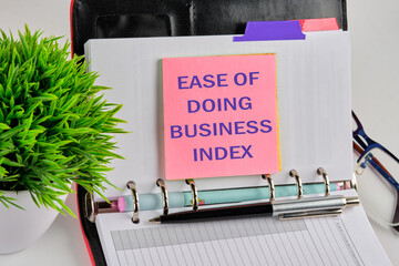 Business index concept. Copy space. Ease of doing business index symbol on a sticker on the background of a blank sheet of notepad