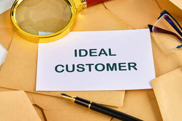 Business ideal customer concept. Copy space. Ideal customer symbol on a blank sheet near a pen, magnifying glass and glasses