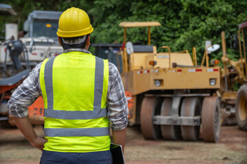 Road construction inspector Standing and inspecting work at the construction site.