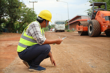 Road construction inspector Standing and inspecting work at the construction site.