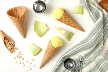 Ice cream cones with pieces of fresh melon on a white background