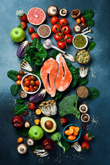 Top view, vertical photo. Healthy food clean eating selection. Superfood, fish and fruit.