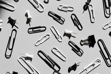 close up of various type of paper clips over grey
