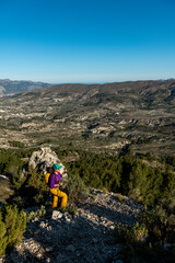 A woman hiking in the mountains, Serrella peak, Quatretondeta, Alicante, Spain - stock photo