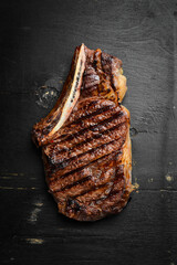 Steak. Grilled steak on the bone. Roasted piece of meat. Free space for text.