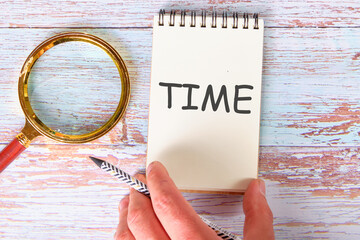 Time Concept TIME TEXT a man's hand takes a notebook with the inscription