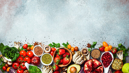 Top view. Healthy food clean eating selection: fresh fruits, berries, superfood, nuts and mushrooms. On a gray concrete background.