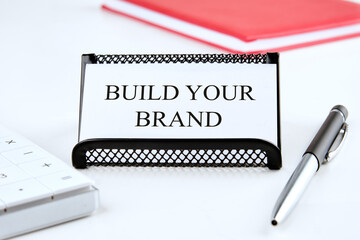Branding rebranding marketing business concept. BUILD YOUR BRAND words on a business card on a white background