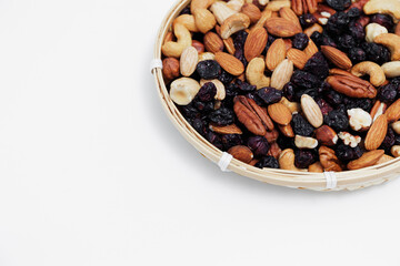 top view of wooden bowl with mixed nuts and copy space on white table