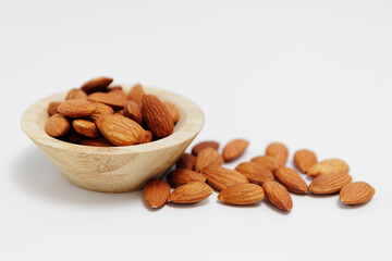 bowl of almond nuts on white table background