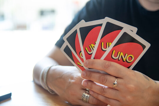 Barcelona, April 5th 2024: Girl holding cards of UNO game in a play.