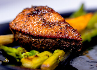 fried duck fillet with golden crust and seasonings green asparagus and orange 