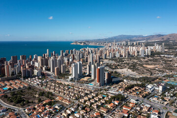 Aerial drone photo of the beautiful city of Benidorm in Spain in the summer time showing high rise...