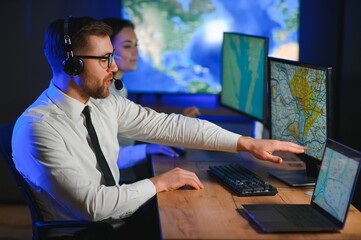 Male Data Scientist Works on Personal Computer Control and Monitoring Room. Map Surveillance of...
