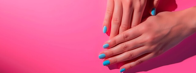 Fototapeta premium Female hands with perfect manicure in trendy neon light on pink background. Beauty concept.