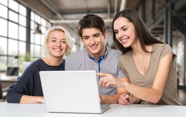 Happy international young students studying together