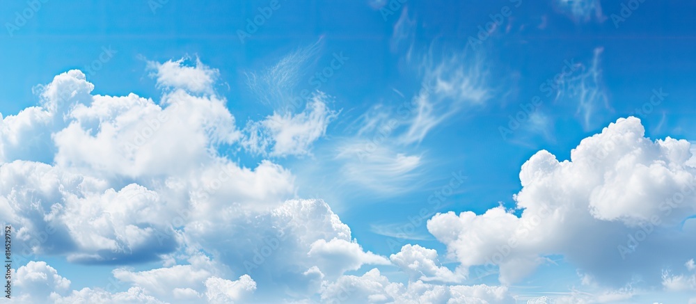 Aufkleber The serene light blue sky is adorned with fluffy clouds creating a picturesque natural backdrop There is ample copy space in the image