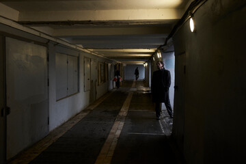 a serious man in a black coat on the street in Krasnoyarsk