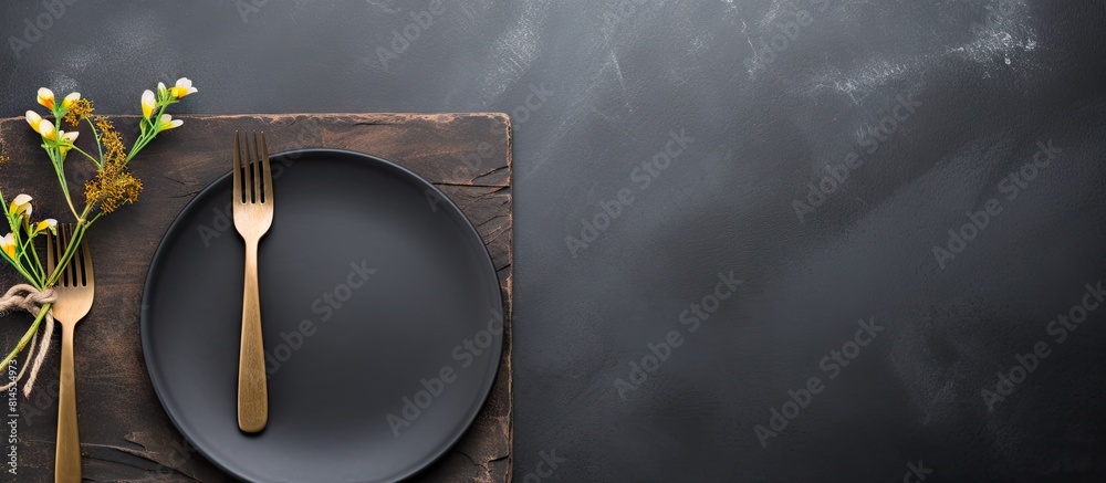 Aufkleber Flat lay of a slate background showcasing an empty gray dish accompanied by a knife and fork accented with a cotton branch Ample copy space image available to display your menu or recipe on a menu car