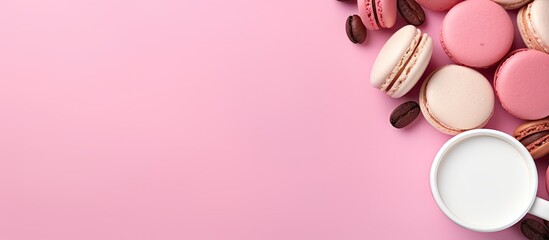 Fototapeta premium Coffee beans surround a large white paper cup in a mockup on a pink background providing ample copy space for your text