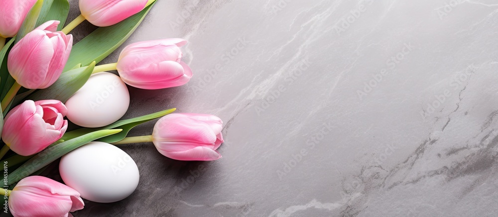 Poster a copy space image featuring pink tulips and easter eggs arranged on a stone surface