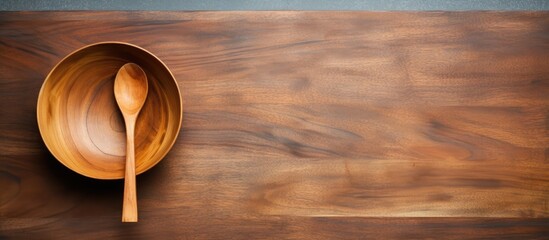 A top view image of an empty wooden bowl along with a fork spoon and cutting board The background offers a template for a food display montage with ample free space for text
