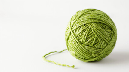 Ball of green cotton yarn on white background