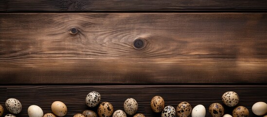 A top down view of quail eggs on a wooden table with plenty of empty space for adding text or other elements in the image. with copy space image. Place for adding text or design