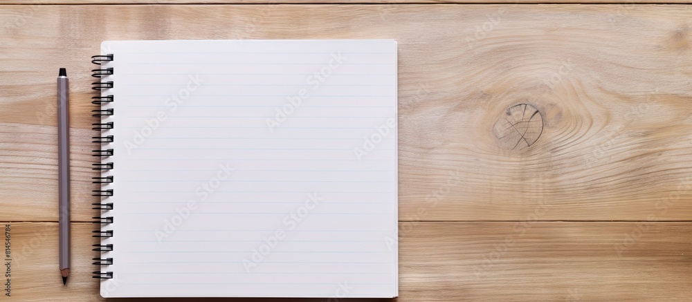 Aufkleber Wooden surface with a blank spiral note pad and silver pen perfect for capturing ideas and thoughts creating a copy space image